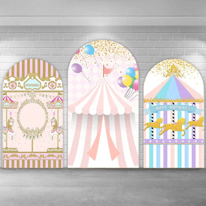 Three-panel carnival-themed arched backdrop set with a golden carousel, a pink circus tent, and a pastel carousel featuring golden horses and a 'Happy Birthday' banner.