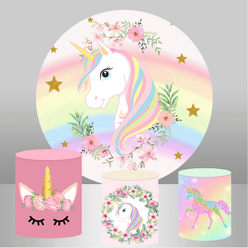 Rainbow unicorn-themed party set featuring a round backdrop with a unicorn and rainbow design, surrounded by flowers and golden stars, accompanied by three cylinder covers with matching unicorn-themed designs.