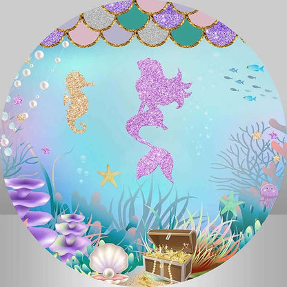 Round backdrop with a glitter pink mermaid silhouette, golden seahorse, treasure chest, and colorful coral reef design.