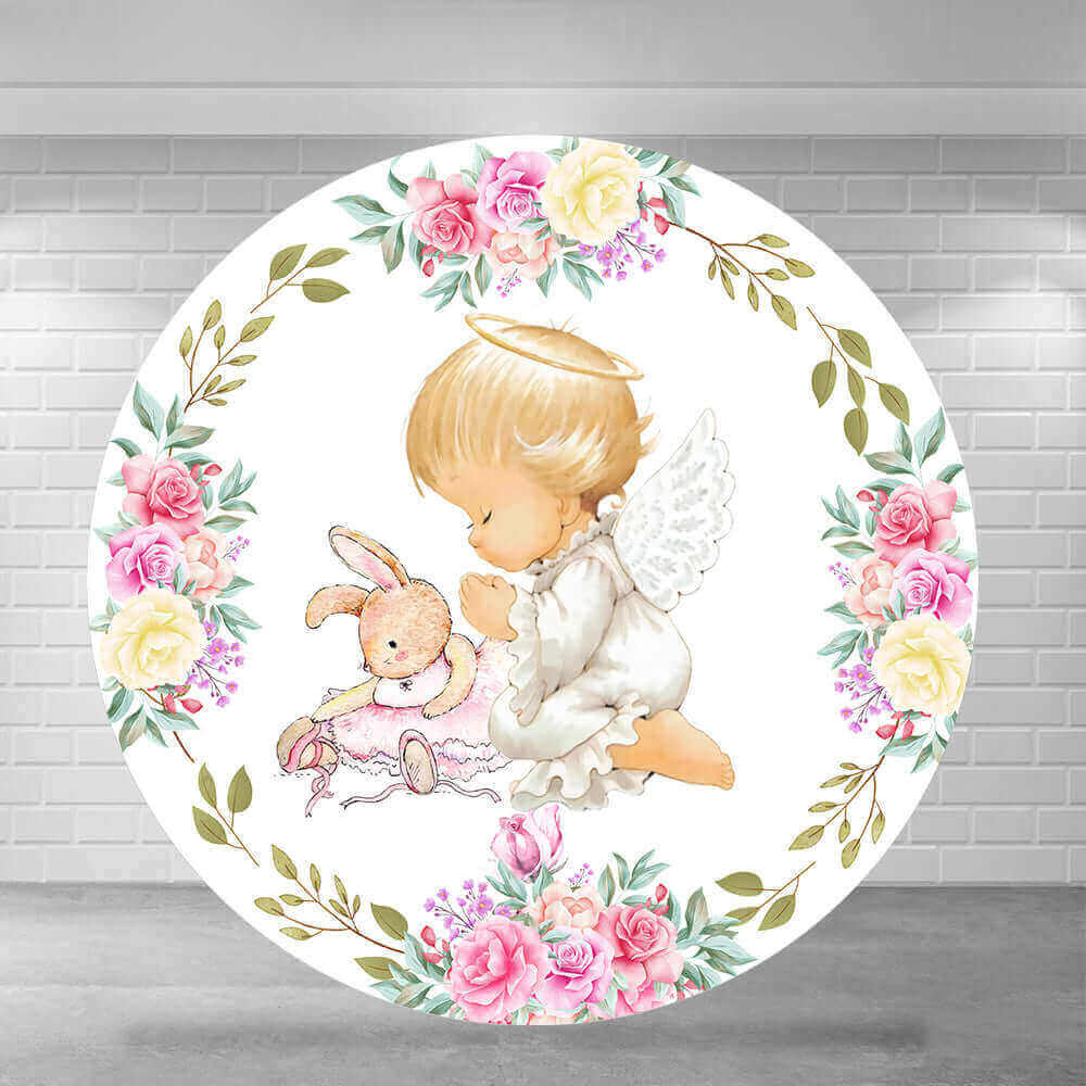 Round baptism backdrop featuring a baby angel kneeling in prayer next to a bunny, surrounded by floral arrangements with roses and greenery.