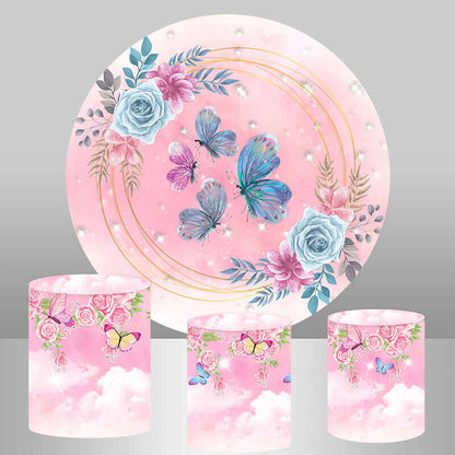 A pink floral-themed party decor set featuring a circular backdrop with butterflies, roses, and golden rings, along with three cylinder covers with matching floral and butterfly designs.