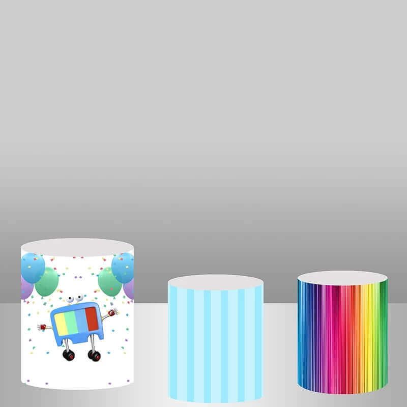 Set of three cartoon-themed plinth covers featuring a robot with balloons, pastel blue stripes, and rainbow stripes, designed to complement a kids’ cartoon party.