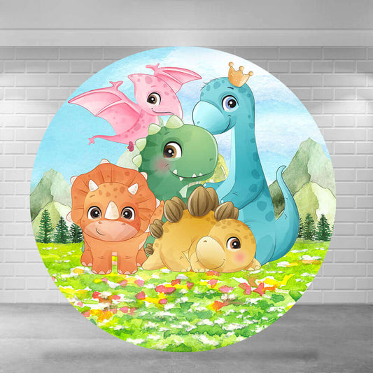 Round dinosaur-themed party backdrop featuring cartoon dinosaurs in a colorful meadow with mountains and trees in the background.