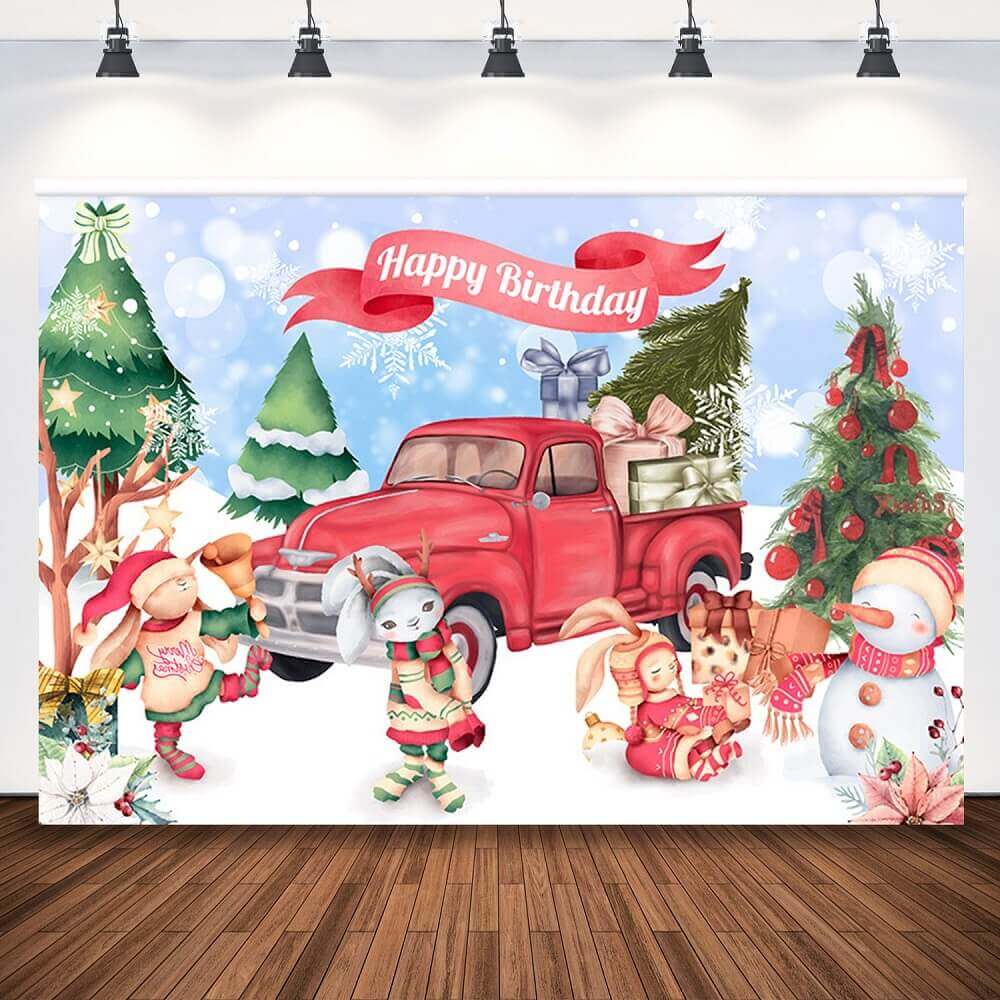 Holiday-themed photography backdrop featuring a red truck with gifts, snowman, decorated Christmas trees, and cartoon animals celebrating a birthday.