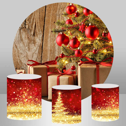 Christmas decoration set featuring a round backdrop with a rustic wooden background, a decorated Christmas tree with red ornaments and gifts, and three red glitter cylinder covers with gold accents.