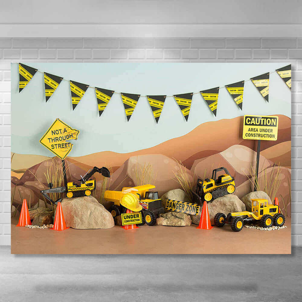 Construction-themed party backdrop featuring toy excavators, dump trucks, cones, caution signs, and a rocky terrain background with a construction banner, perfect for kids’ birthday celebrations.