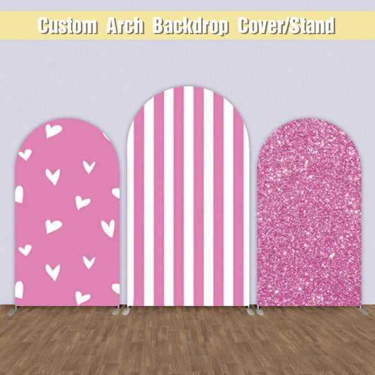 A three-piece pink arched backdrop set with designs including white hearts on a pink background, pink and white vertical stripes, and sparkling pink glitter.