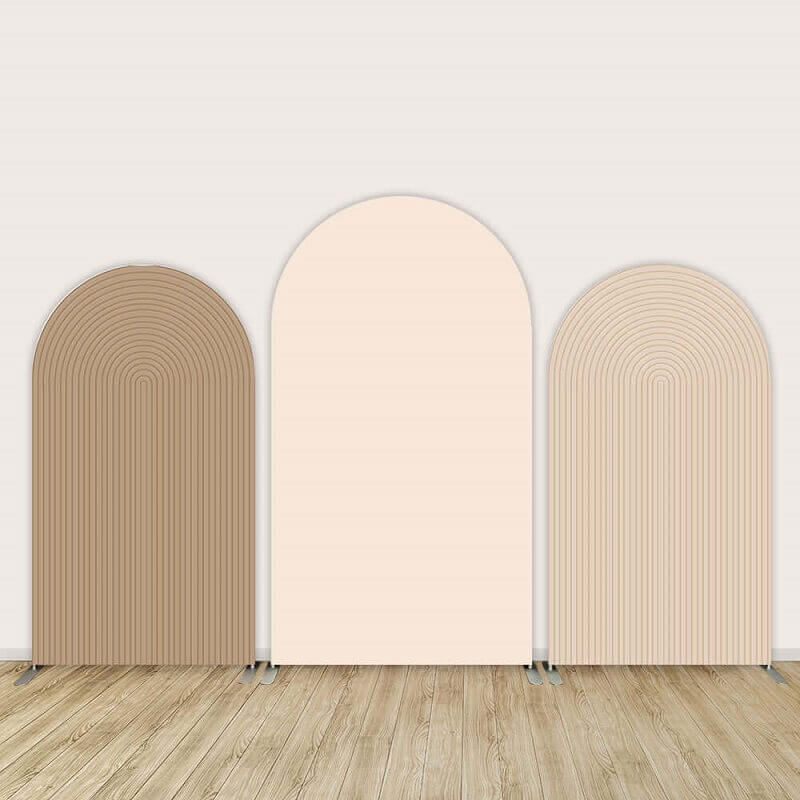 Triple-panel arched backdrop set in beige, nude, and cream tones with a layered arch design, standing on a wooden floor with a light beige wall background.