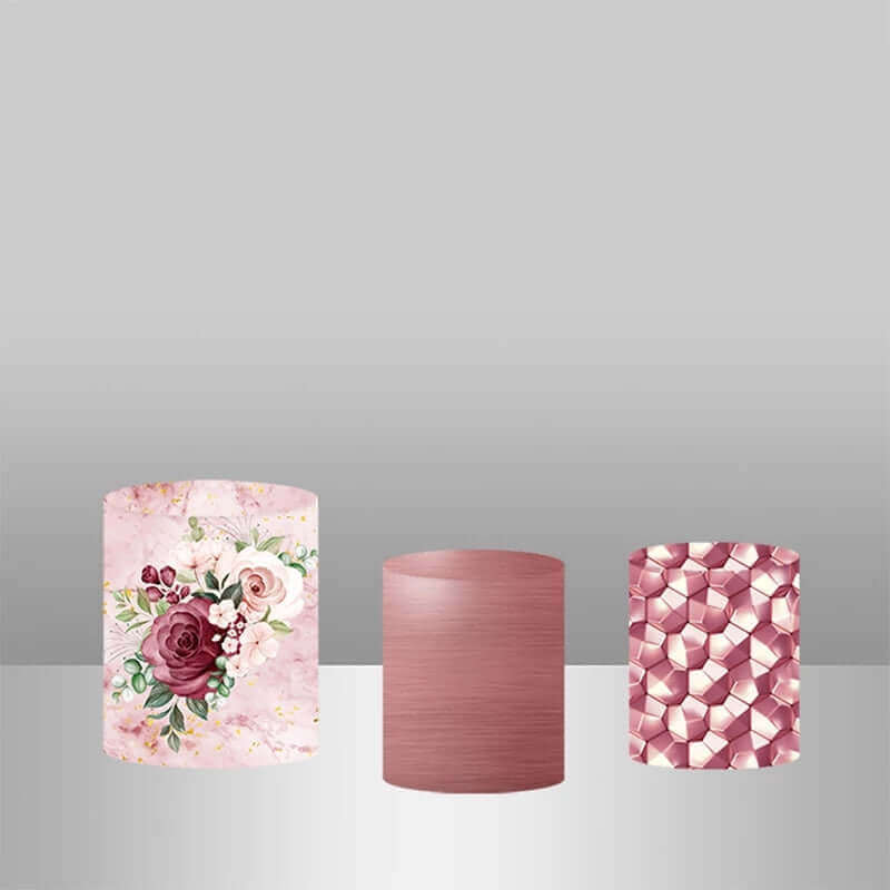 Set of three wedding-themed plinth covers: one with floral patterns, one solid burgundy, and one with a geometric design in pink tones.