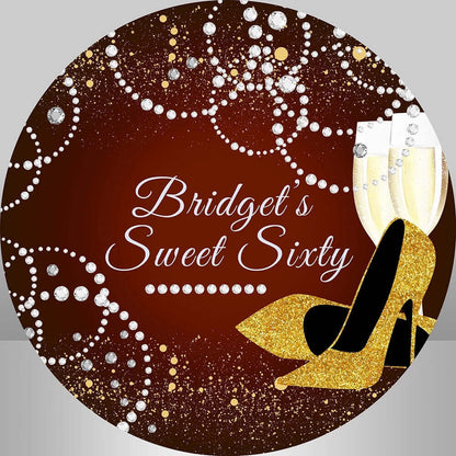 Elegant Sweet Sixty round backdrop featuring a burgundy wine background with gold glitter details, diamond-like patterns, a pair of golden high heels, and champagne glasses, perfect for a 60th birthday celebration.