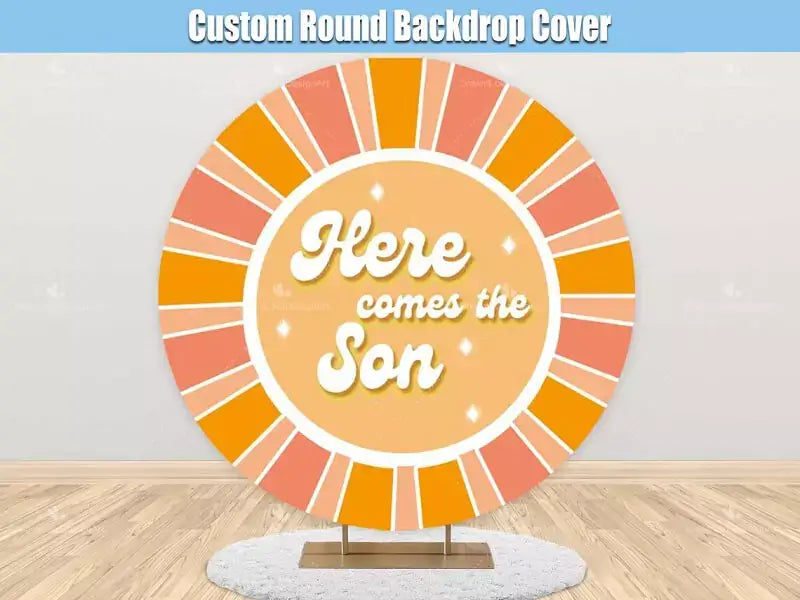 A round backdrop featuring a vibrant 'Here Comes the Son' design with bold orange and yellow sun rays and sparkling details, ideal for baby showers and celebrations.