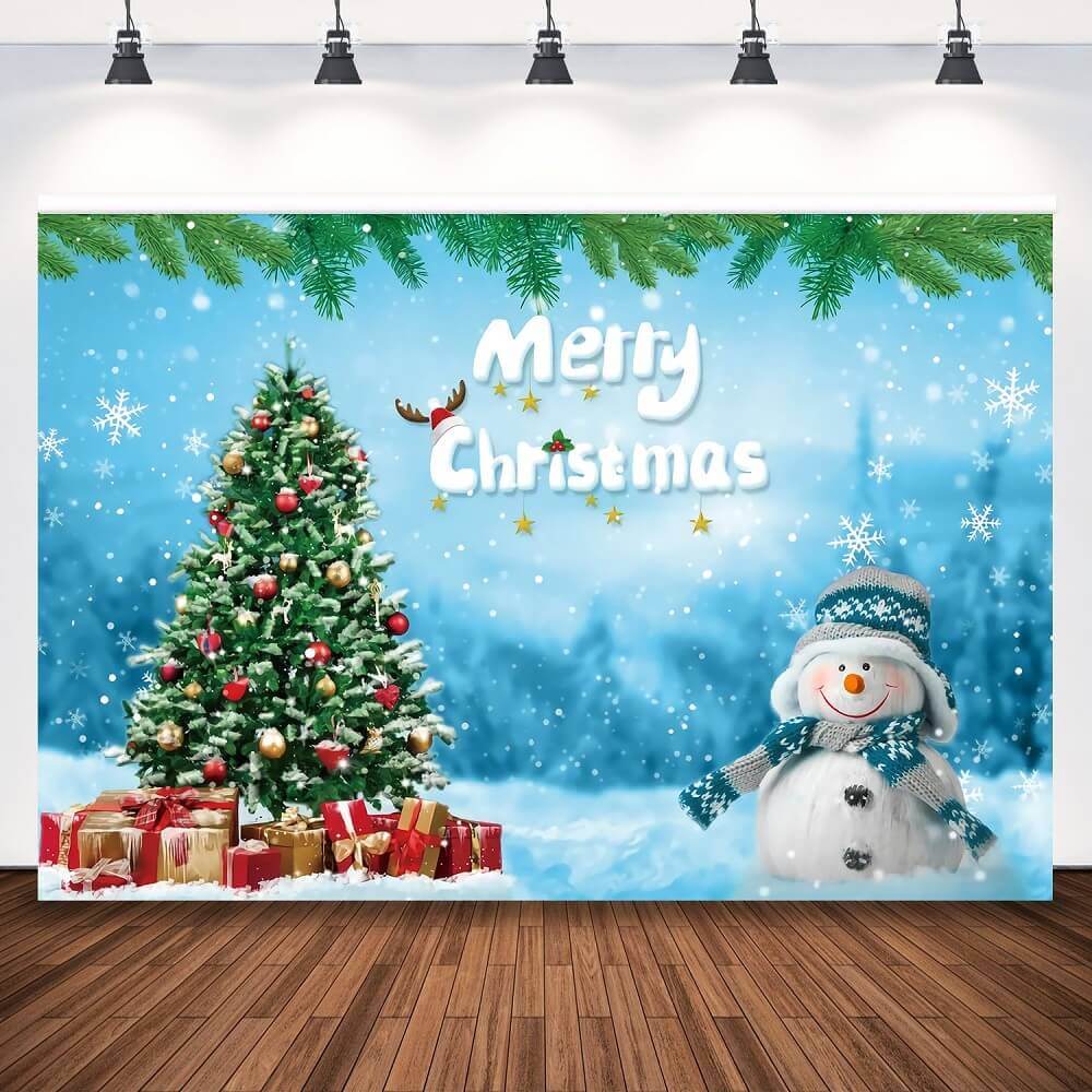 Merry Christmas backdrop featuring a decorated Christmas tree with gifts, a cheerful snowman in a winter scarf and hat, and a snowy winter wonderland with snowflakes and festive decorations.