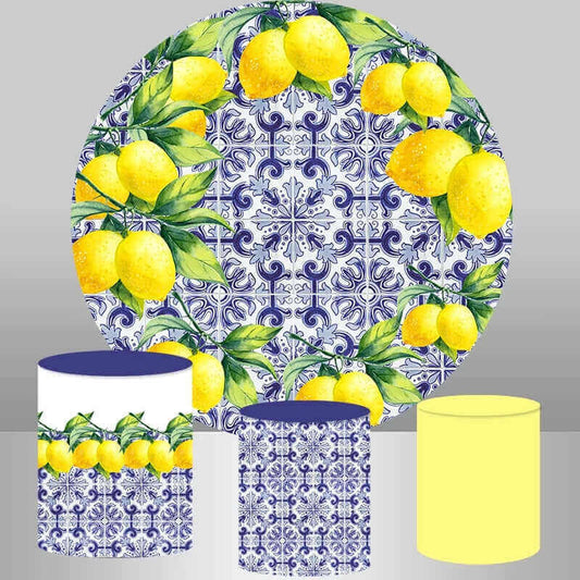 A set of photography props featuring a round backdrop with lemon and blue Spanish porcelain design and three cylindrical covers with matching lemon and blue porcelain patterns, ideal for product photography, events, and creative setups.