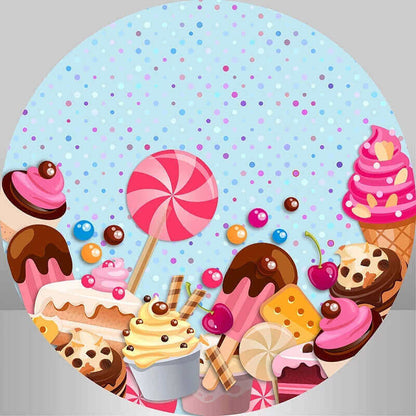 Round backdrop with a candyland design featuring lollipops, ice cream cones, chocolate drizzles, and colorful sprinkles on a blue polka-dot background.