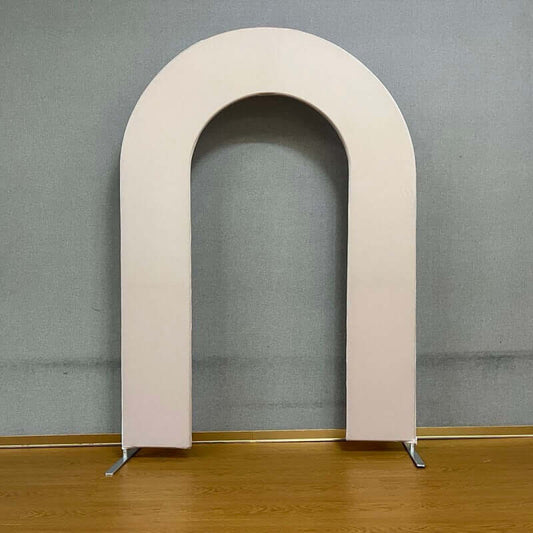 Nude open arch backdrop stand with a minimalist arched design, set against a neutral gray background and wooden floor, perfect for weddings, birthdays, and modern event decor.