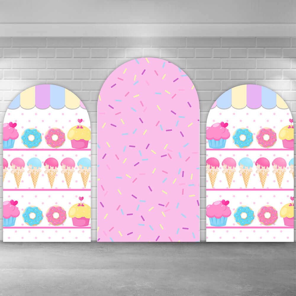 Three-piece sweet candy-themed arched backdrop featuring pink sprinkles in the center and colorful donuts, ice cream cones, and cupcakes on the side panels.