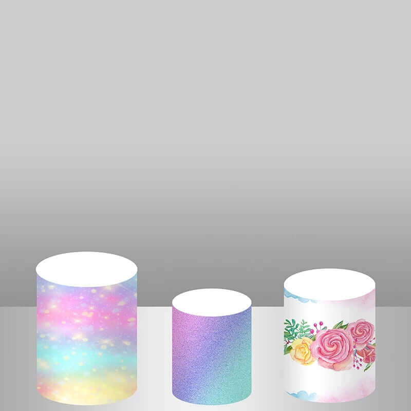 Set of three cylinder covers for unicorn-themed party decor, including rainbow glitter, pastel gradient, and floral patterns, perfect for magical event styling.