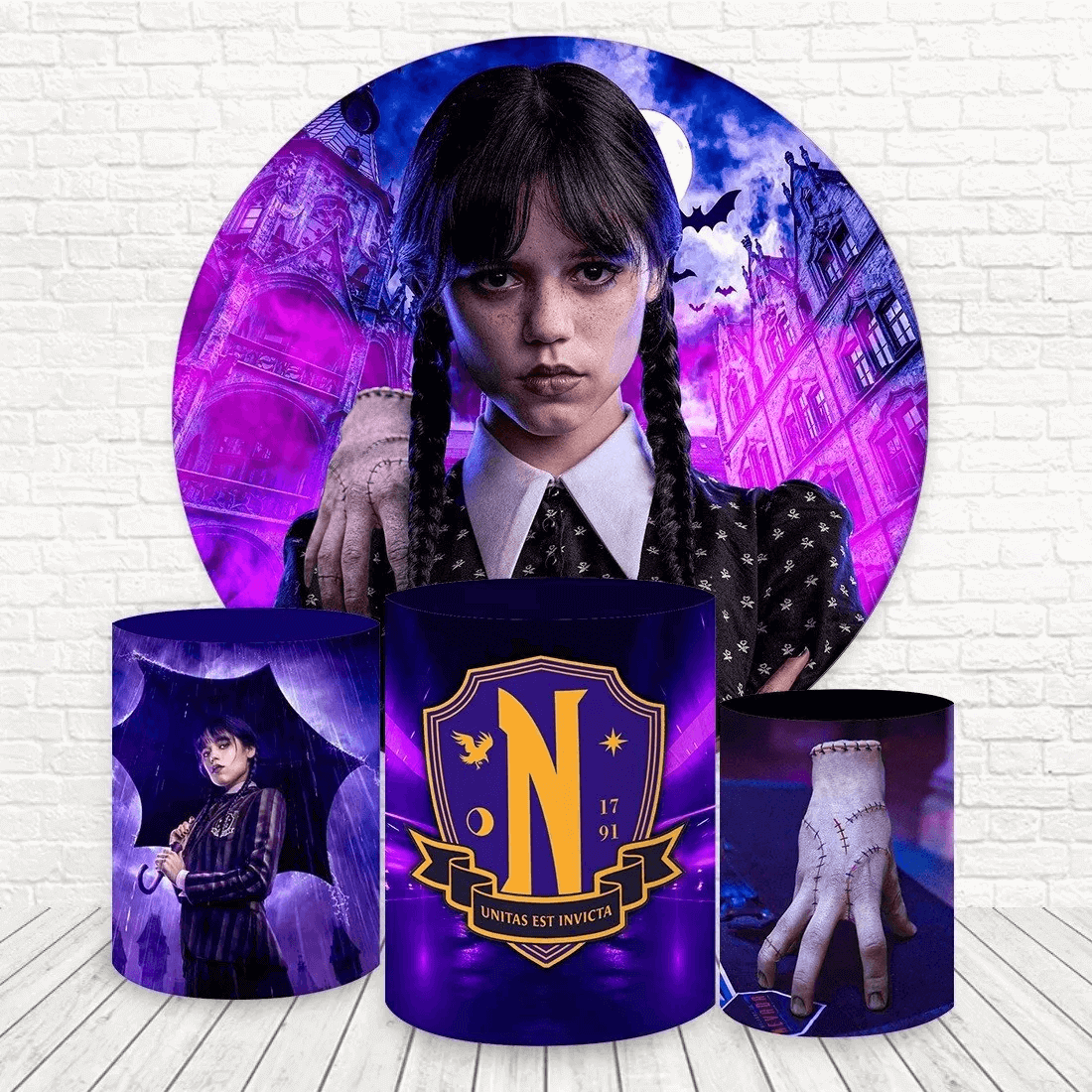 Wednesday Addams-themed party set with a round purple backdrop featuring Nevermore Academy, bats, and Wednesday, paired with gothic cylinder covers.